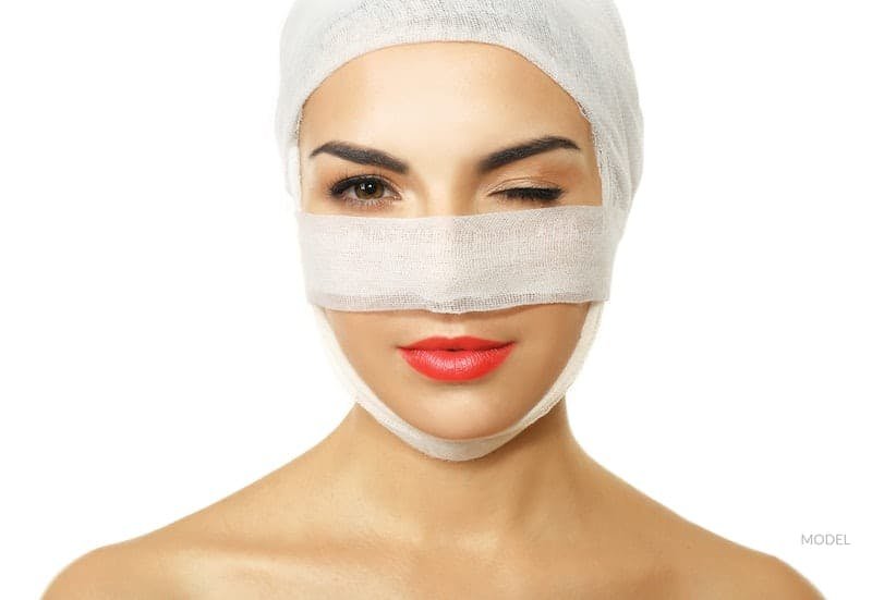 A woman with bandages on her head