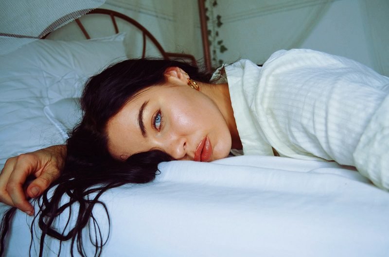 Eye Makeup Ideas for Blue Eyes Over 40 Woman Lying Down on a Bed